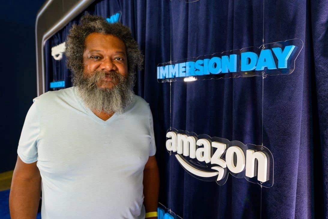 Bonin Bough standing in front of an Amazon Immersion Day backdrop